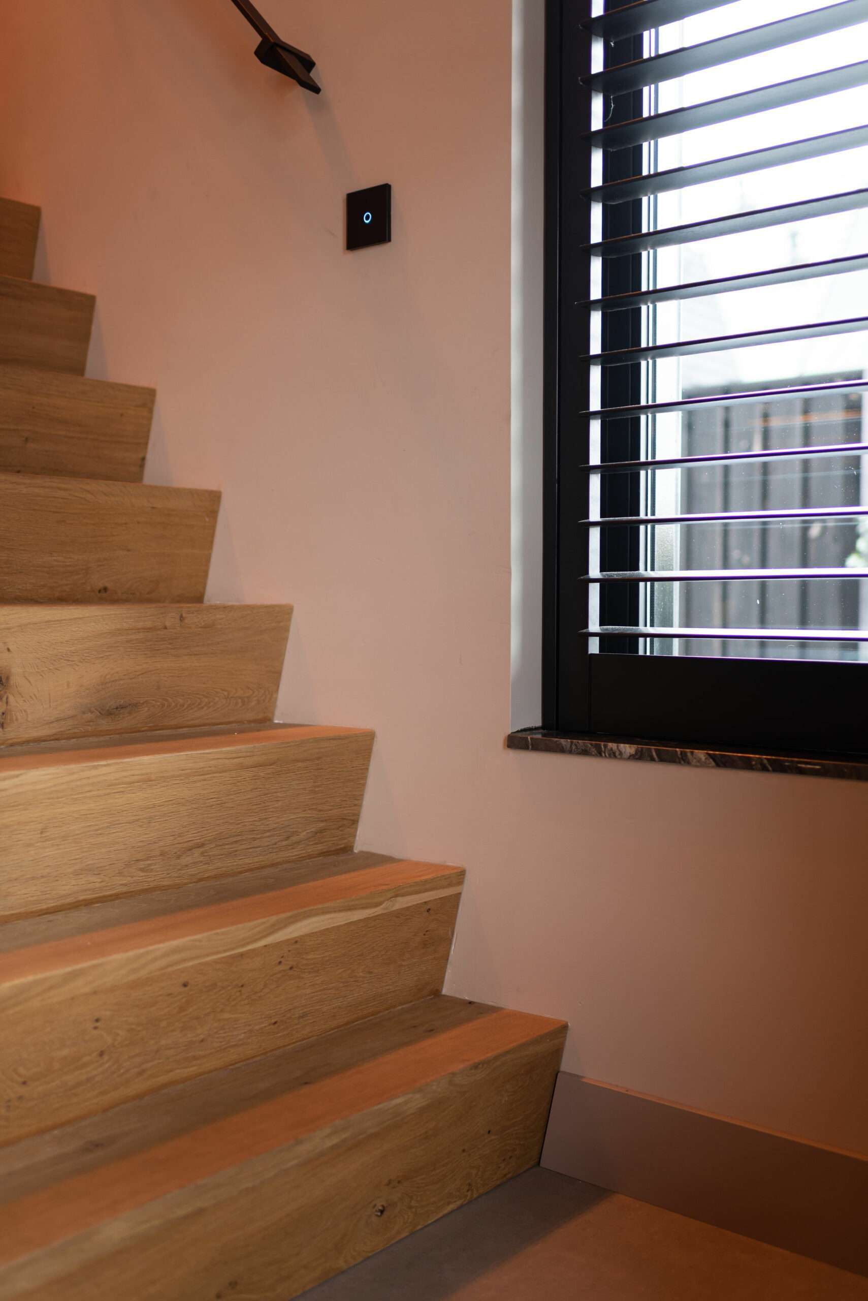 Donkere Blend Abachi shutters naast een houten trap